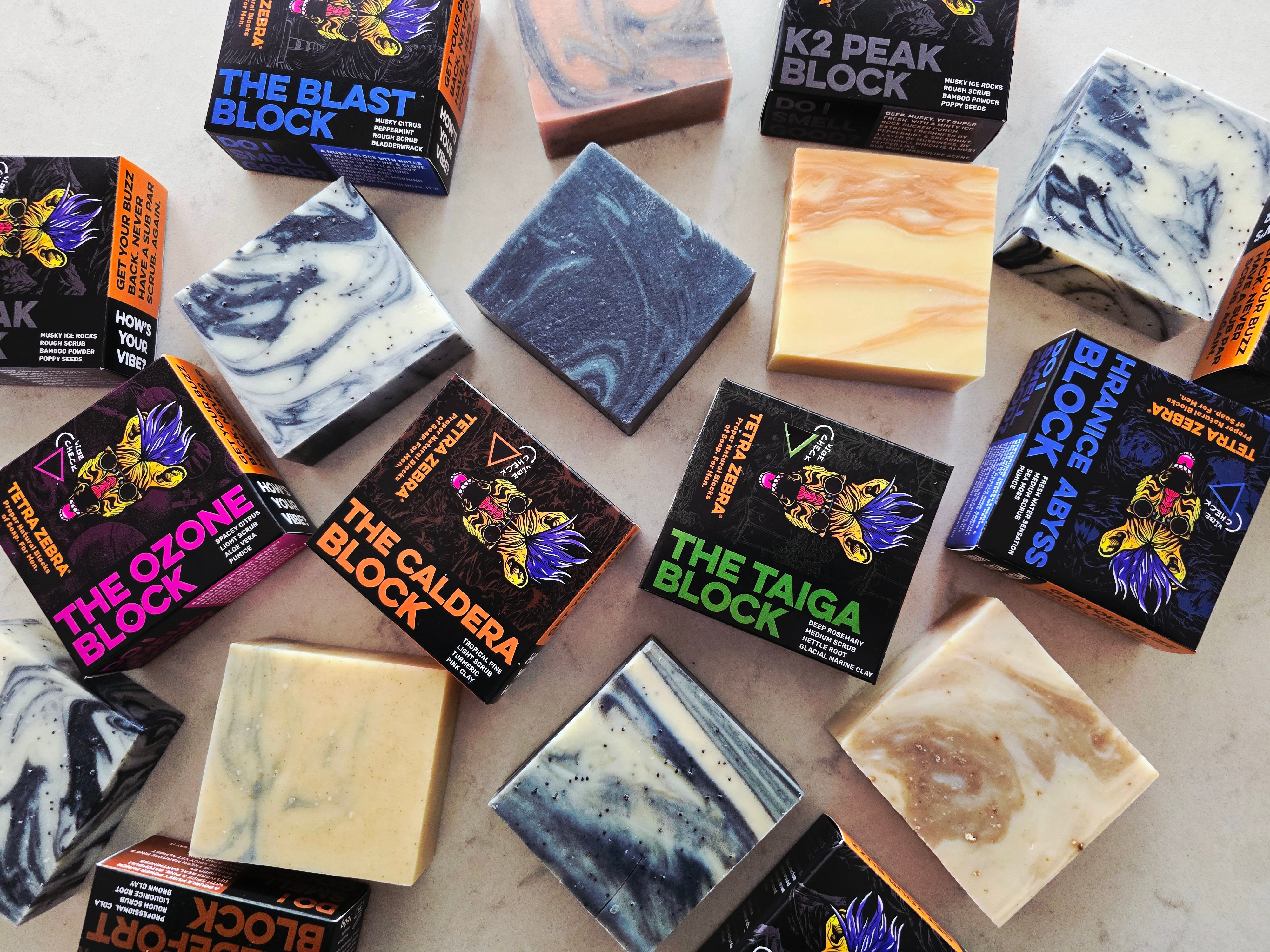 Assorted blocks of soap with packaging on a light surface